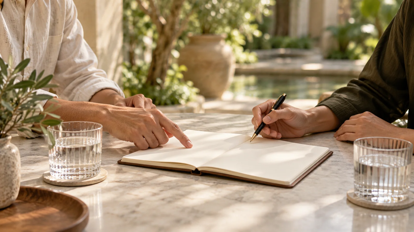 Illustrative buyer consultation with an open notebook and two people discussing details.