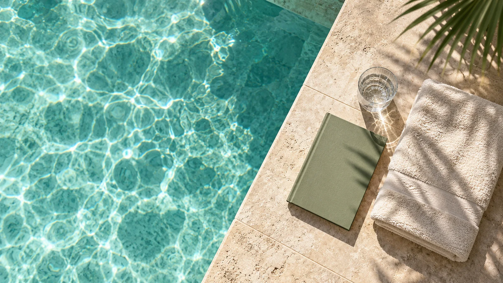 Overhead illustration of a private-pool edge with a towel, book and water glass.