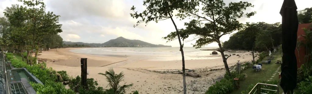 Kamala weather in the rainy season: Kamala Beach on an overcast day, with the bay and hills behind