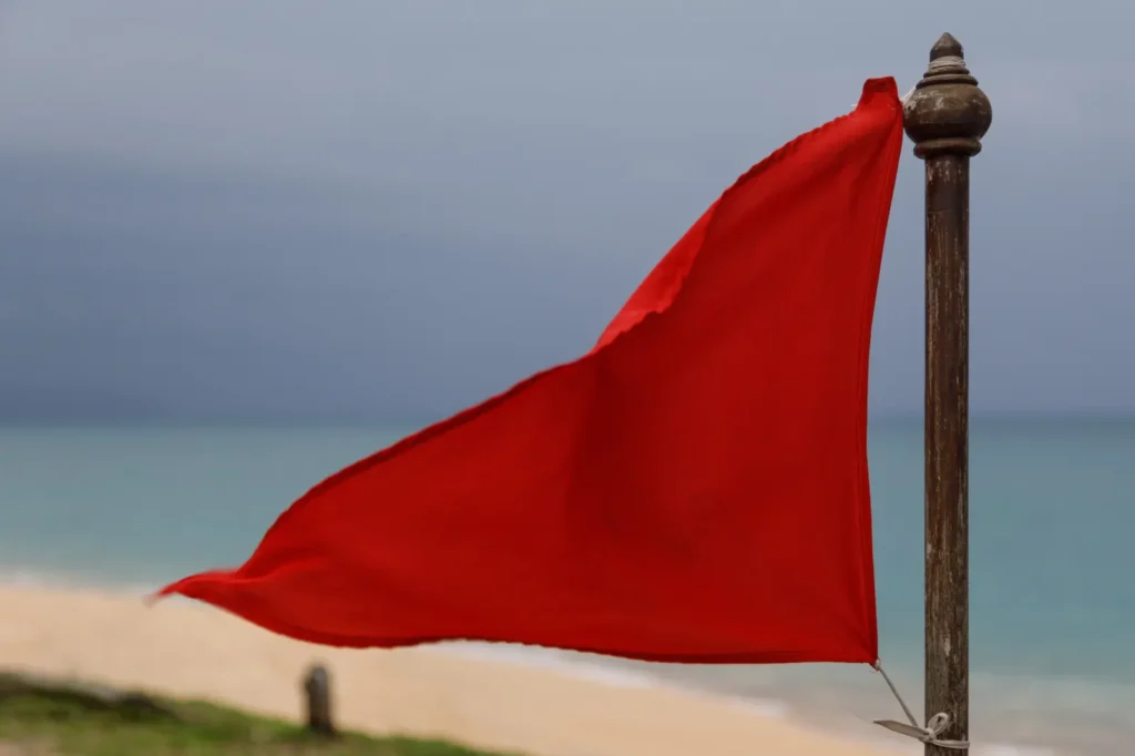 Red warning flag on Mai Khao Beach in Phuket, meaning do not swim